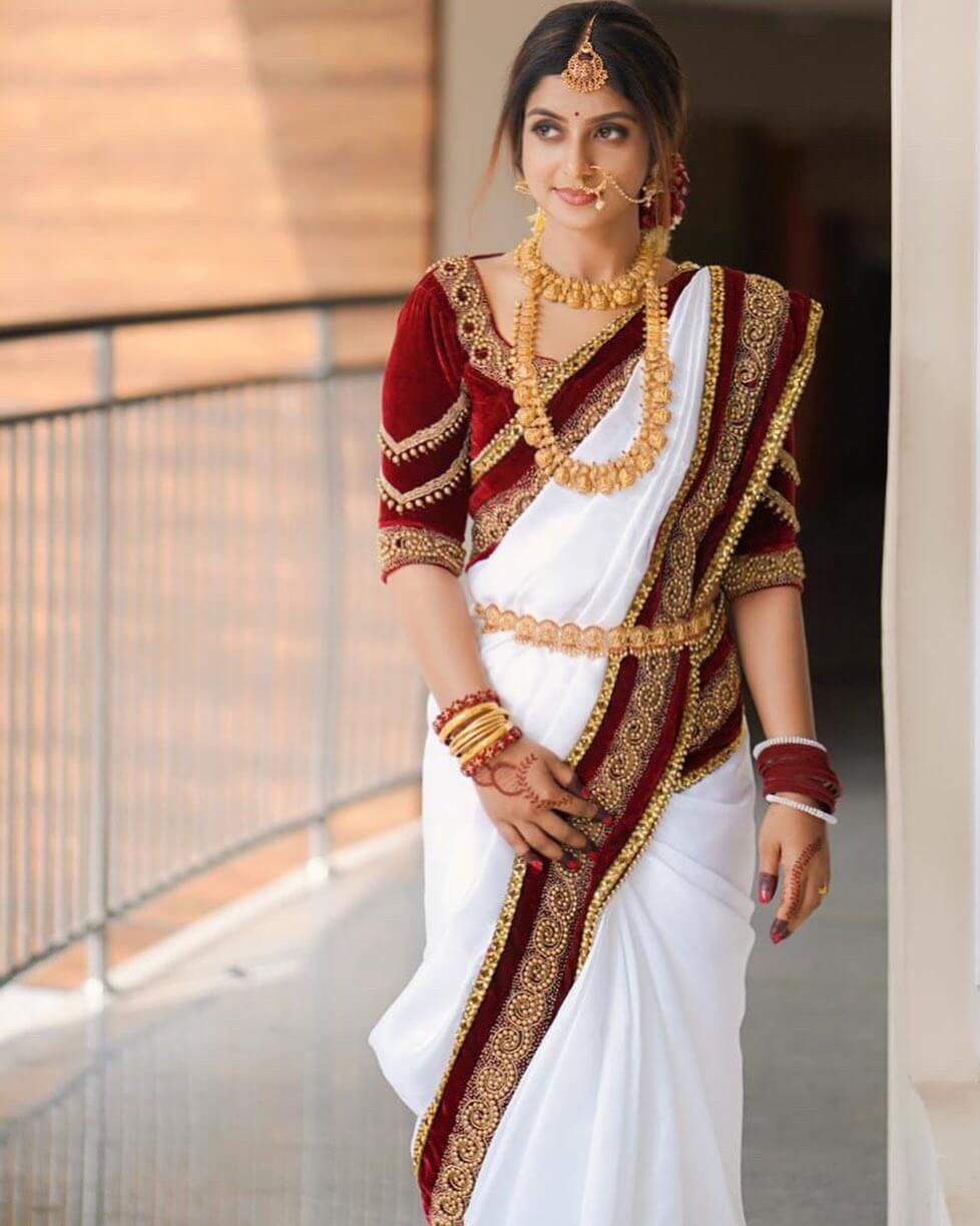 Athmiya Rajan Mesmerizing Look In Her Wedding White & Red Velvet Saree Paired With Red Velvet Blouse & Heavy Gold Jewellery