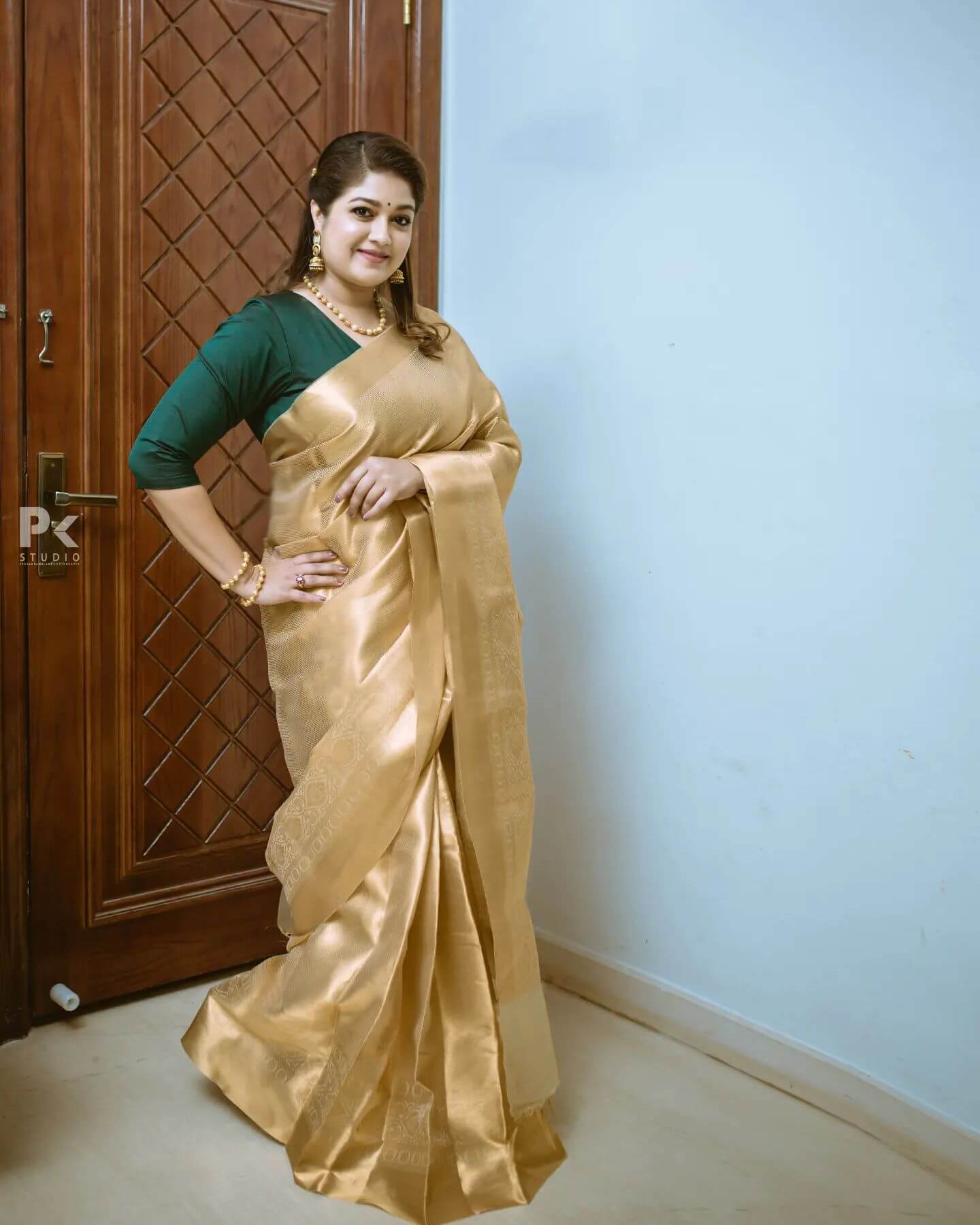 Meghana Raj In Light Golden Silk Saree Paired With Green Solid Blouse