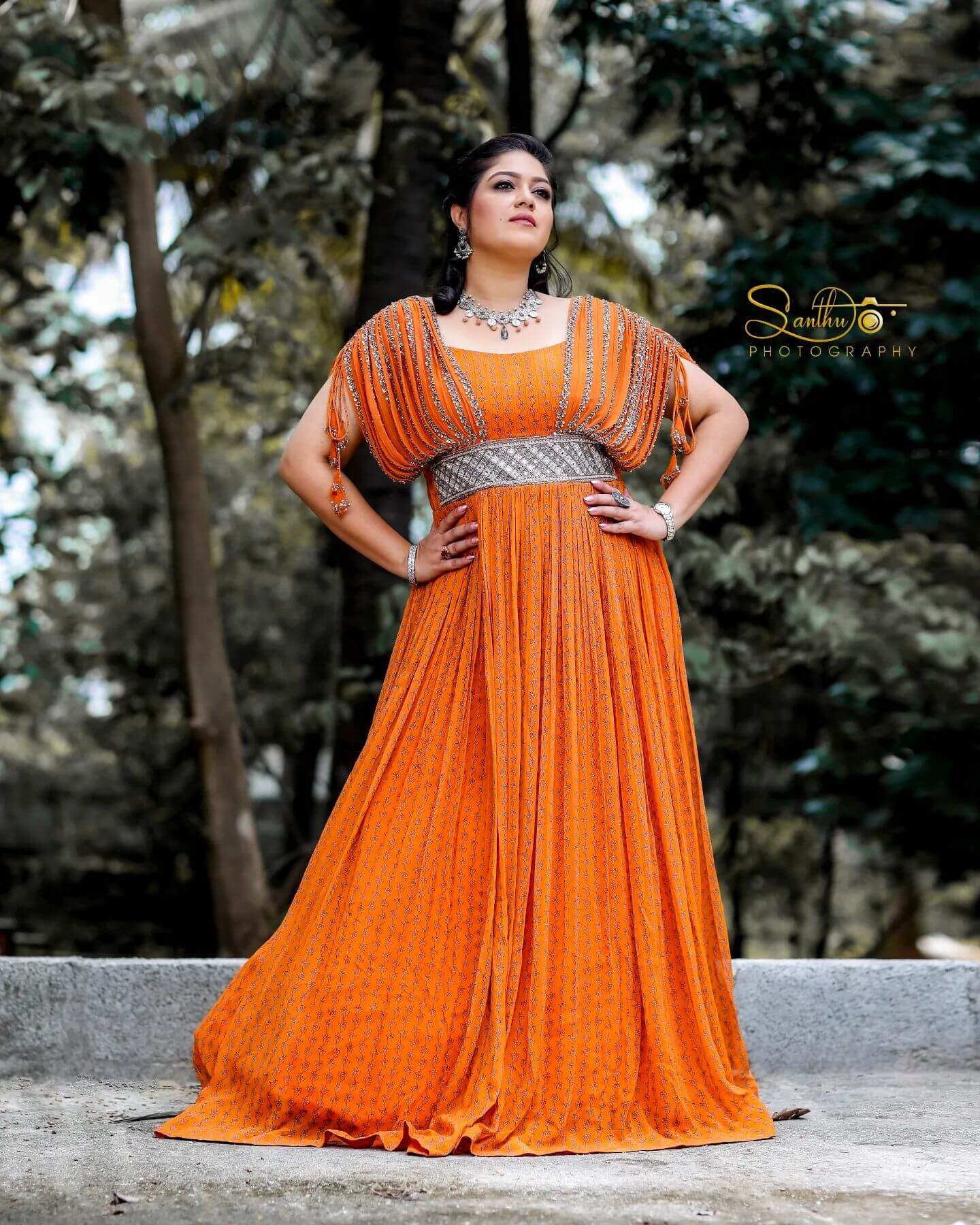 Meghana Raj Stunning Look In Orange Georgette Floral Print Pleated Gown