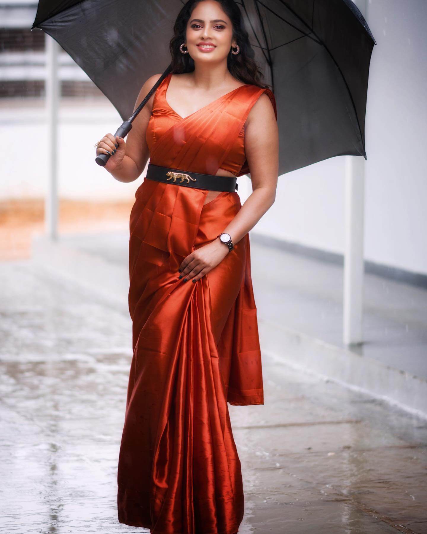 Nandita Swetha Chic & Elegant Look In Orange Satin Solid Saree With Sleeveless Blouse Styled With Black Belt