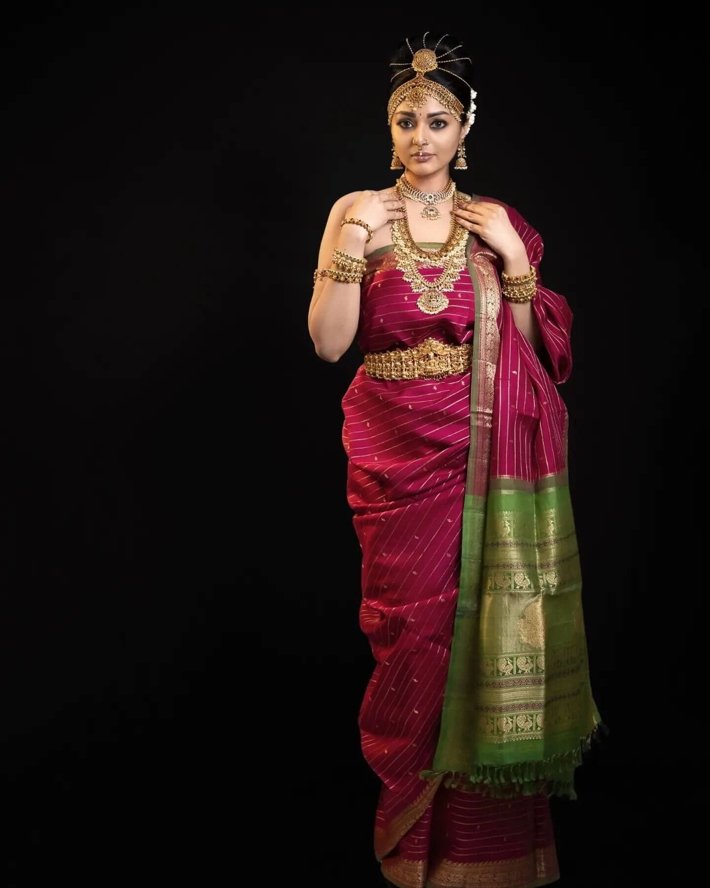 Sanam Shetty In Traditional Saree Look Wearing Wine Golden Strip Saree Paired With Heavy Gold Jewellery