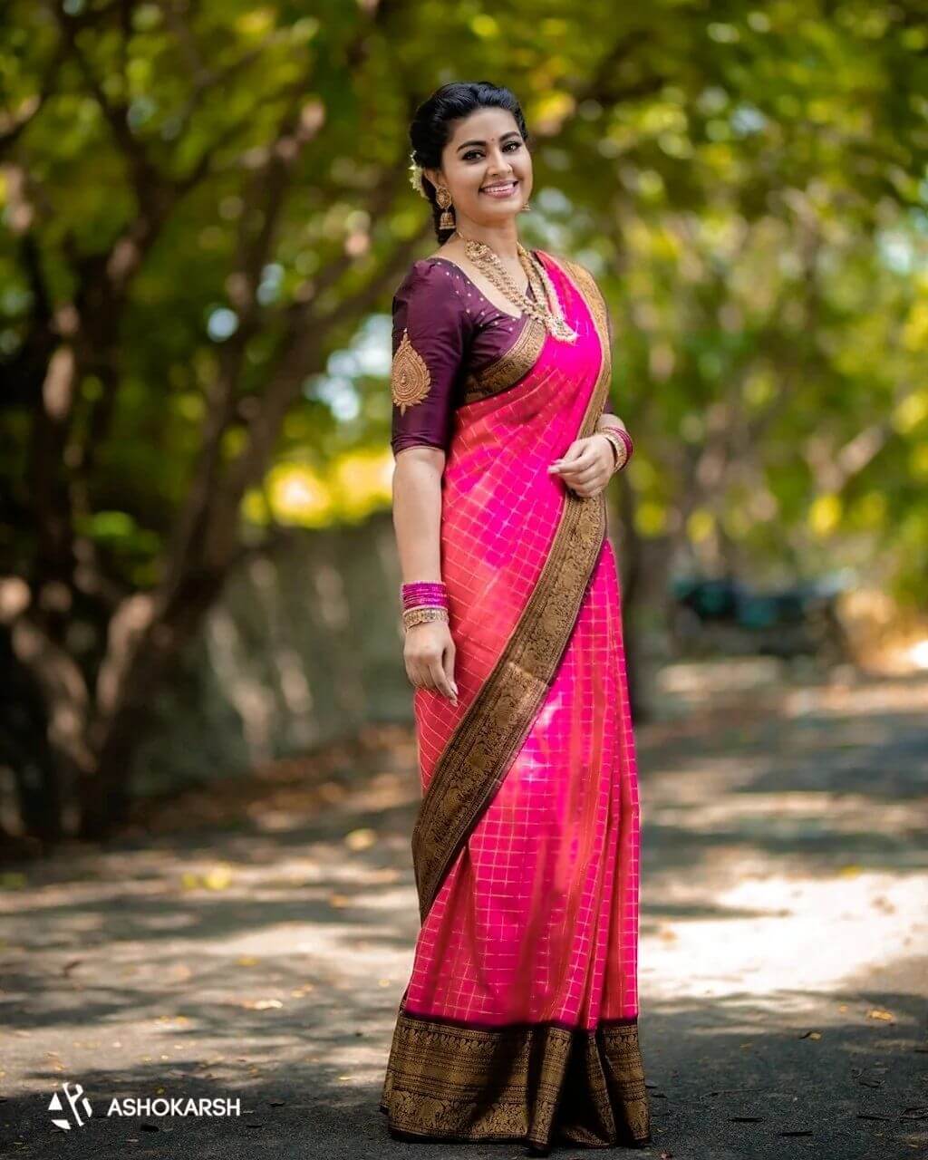 Sneha In Pink & Violet Check Silk Saree Paired With Violet Blouse