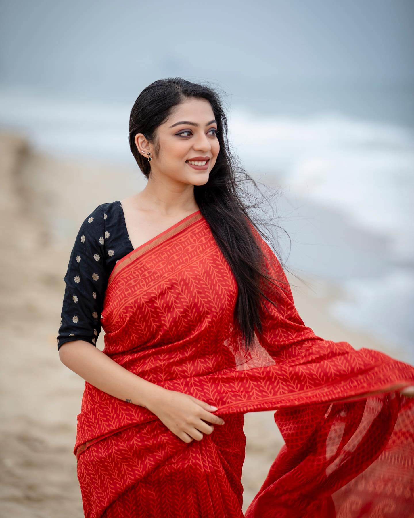 Varsha Bollamma In Red Leaf Printed Saree With Contrasting Black Blouse