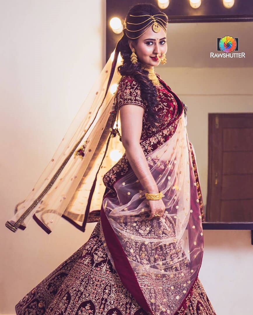 Amulya Dazzling Look In Maroon Bridal Lehenga Paired With Gold Jewellery