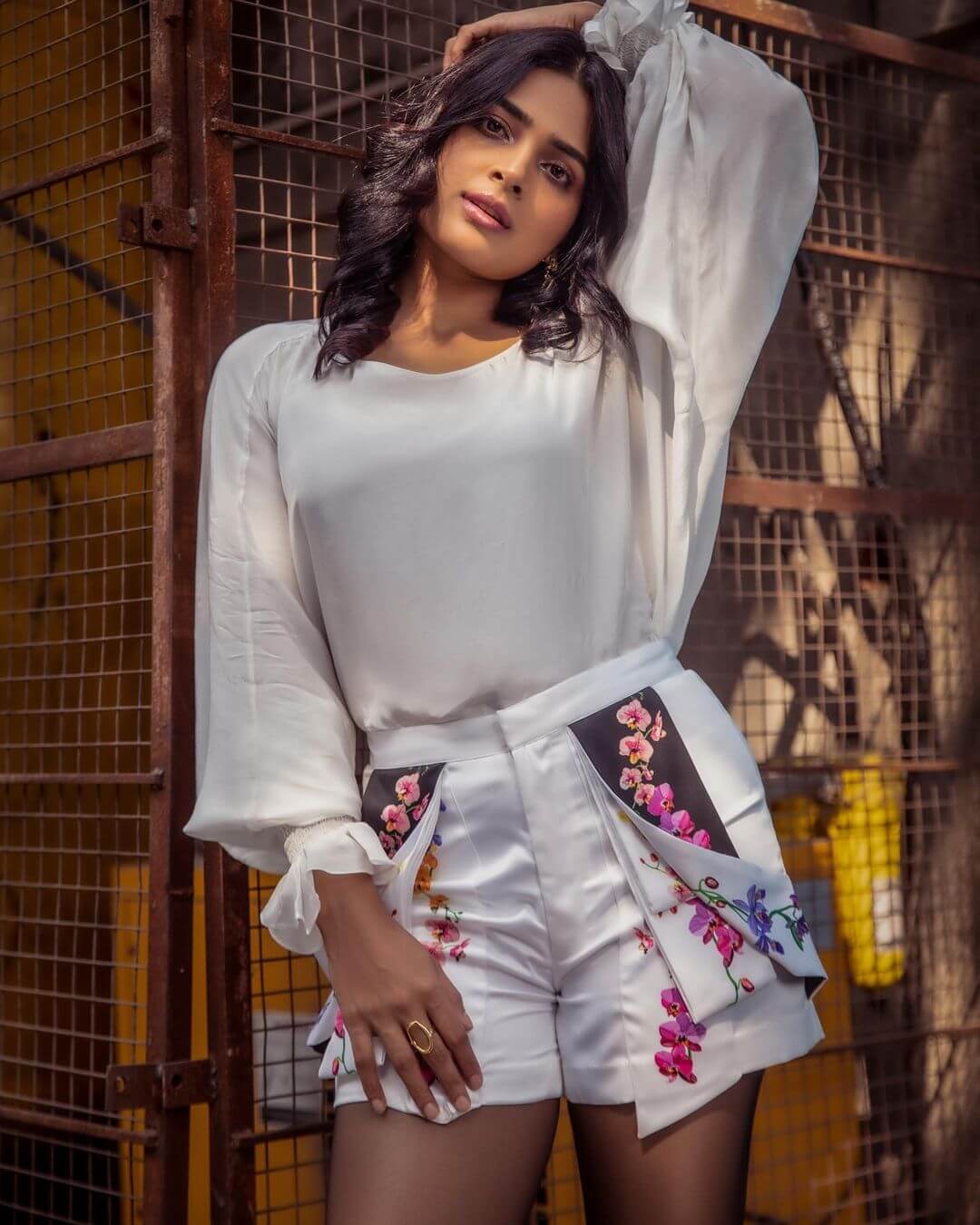 Anagha Maruthora  In White Solid Puffed Sleeves Top With Dramatic Floral Printed White Shorts