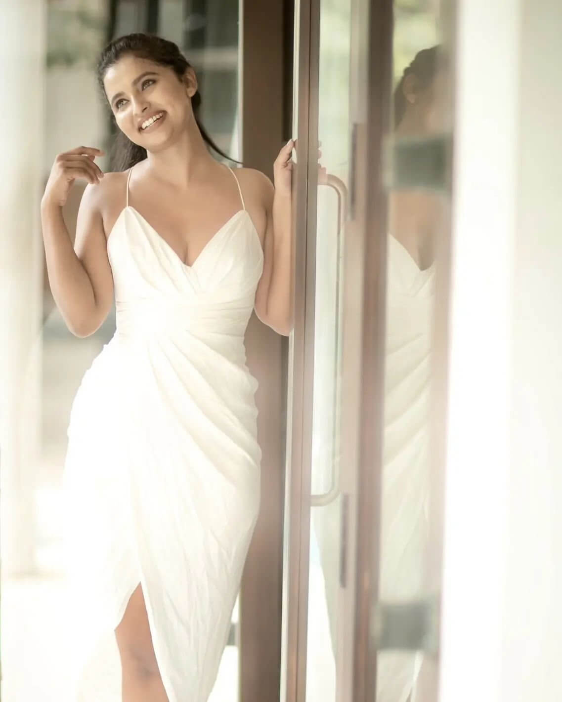 Anicka Vikraman Look Pretty Amazing In White Deep Neck Noddle Strap  Drapped Dress