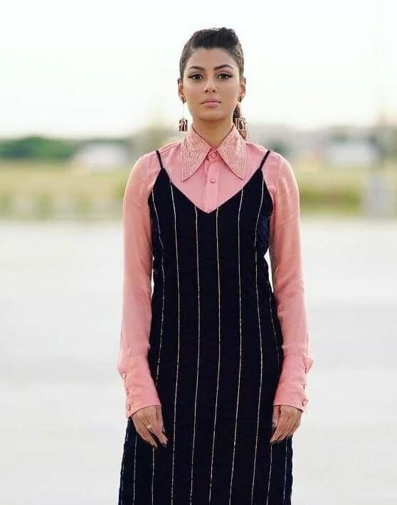Anisha Ambrose Quirky Look In Pink Shirt & Black Long Sleeveless Dress With Chic & Sleek Ponytail