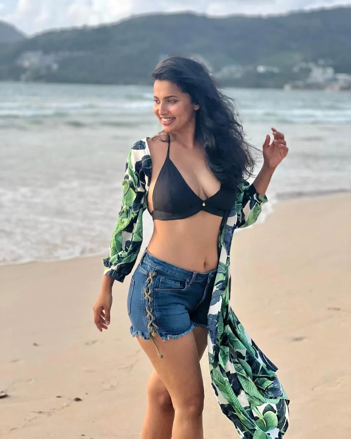 Beach Baby Anicka Vikraman Vacation Look In Black Bikini Top With Denim Shorts Paired With Long Green & Black Shrug