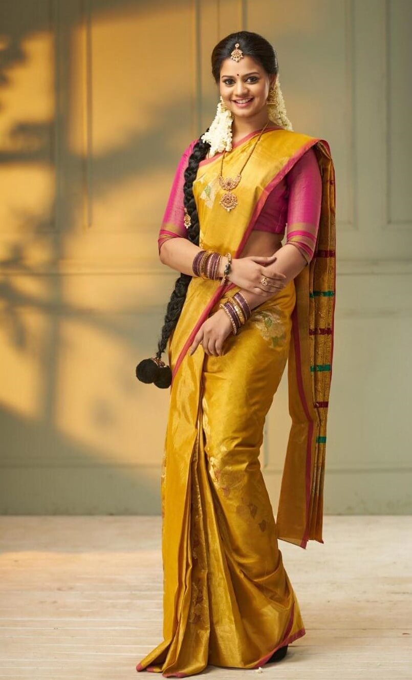 Heroshini Komali In Traditional South Indian Look Wearing Yellow Silk Saree With Pink Blouse & Gold Jewellery