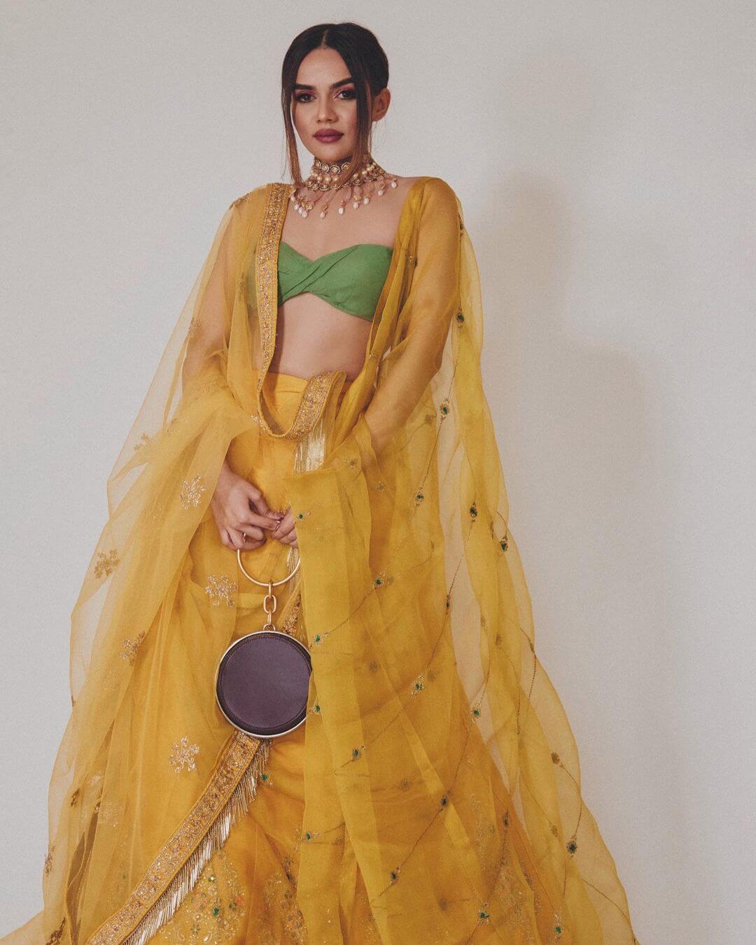Komal Pandey In Yellow Net Gotta Patti Lehenga With Green Tube Bra & Stylish Round Clutch