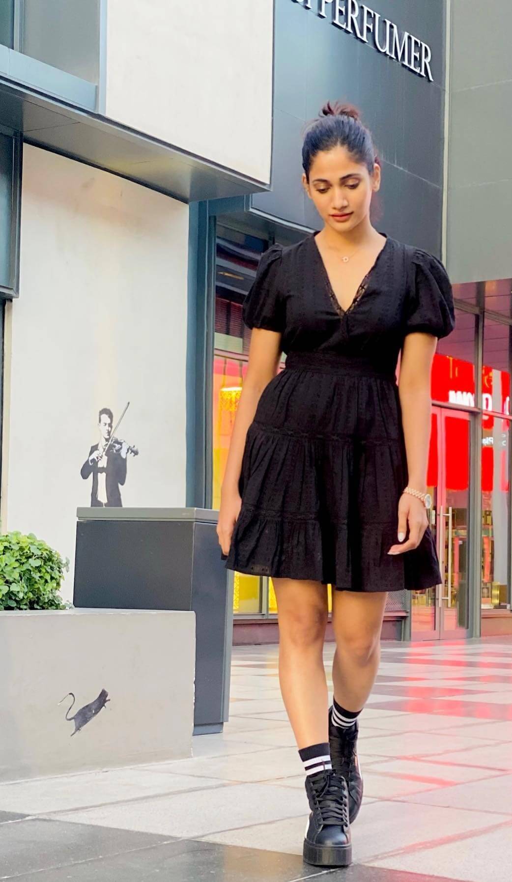 Losliya Mariyanesan Vacation Look In Black V-Neck Frock Dress With Black Sneakers