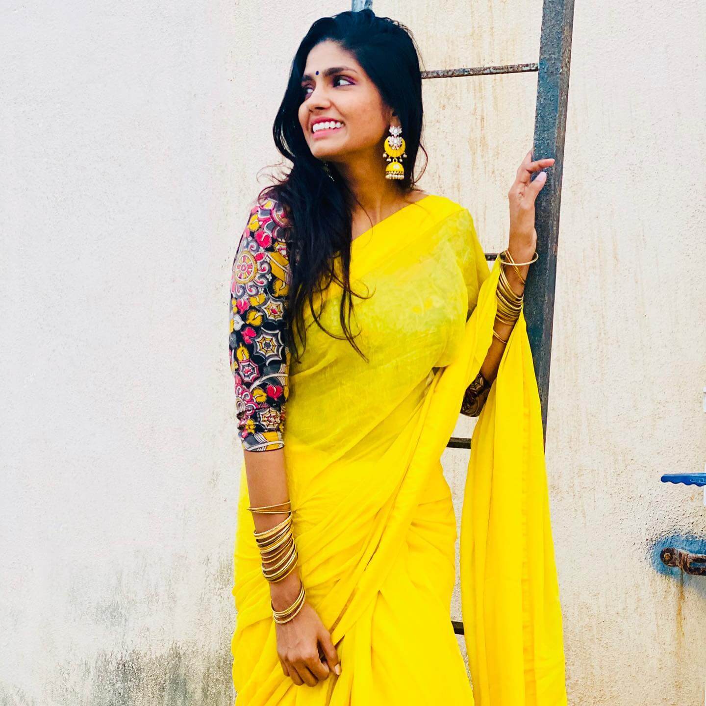 Mutli Talented Niranjani Ahathian In Yellow Plain Saree Paired With Blue Printed Quater Sleeves Blouse With Opened Hairstyle