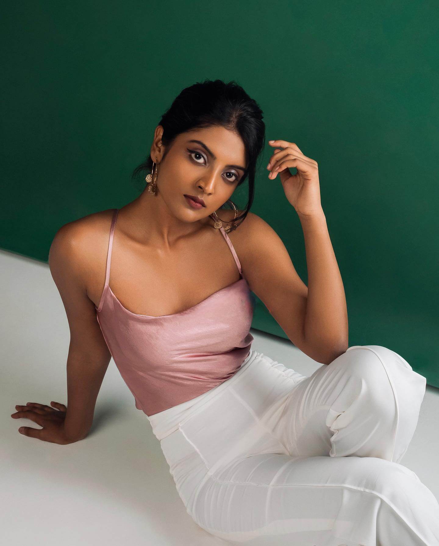 Nivedhithaa Sathish In Dusky Pink Halter Neck Noddle Strap Satin Top With White Pants