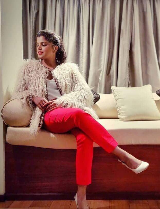 Pooja Devariya In Beige Shaggy Faux Fur Jacket With White Tank Top & Red Fit Pants Paired With White Pumps