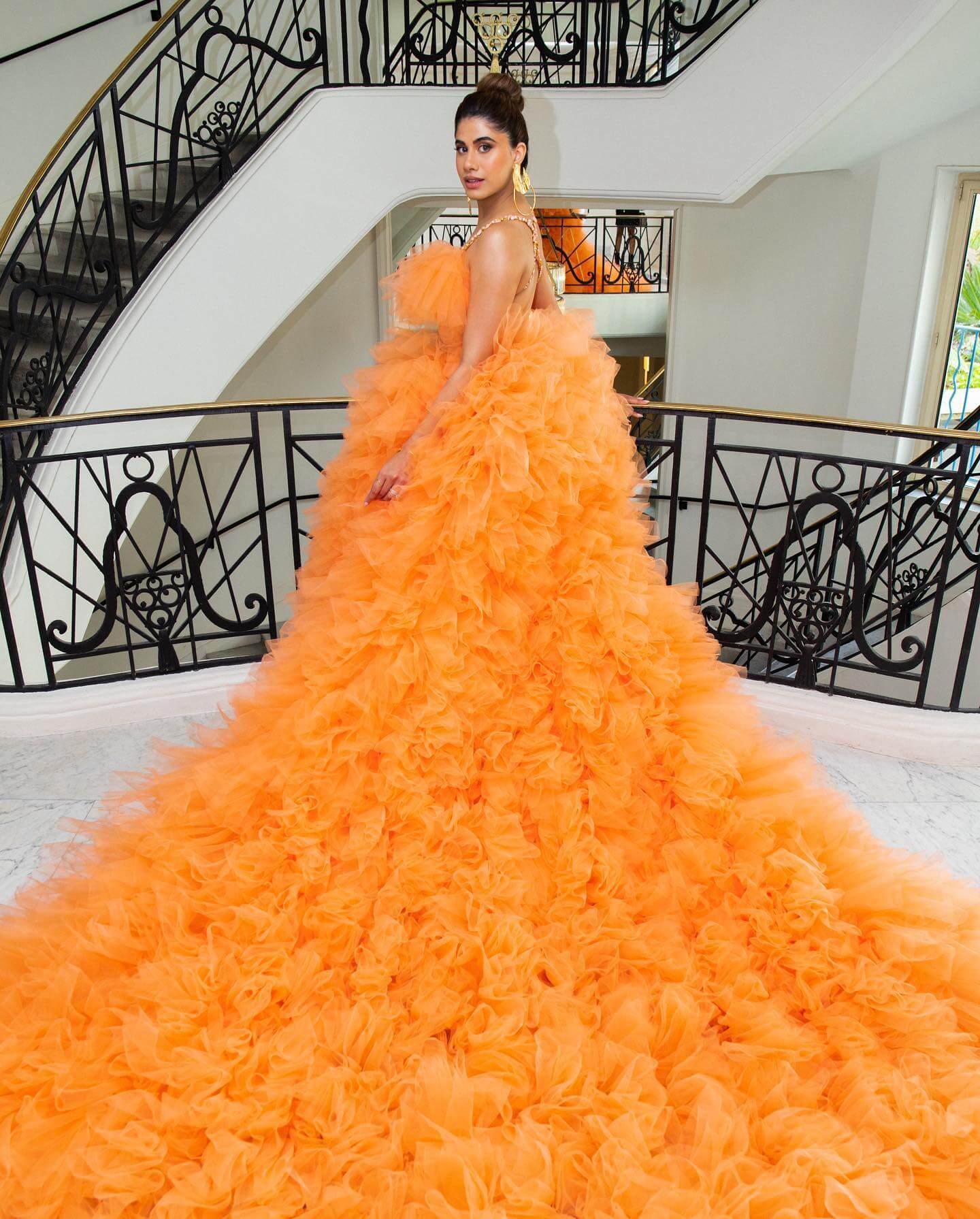 Social Media Personality Malvika Sitlani Cannes Look In Orange Full Ruffled Gown With Sleek Hair Bun