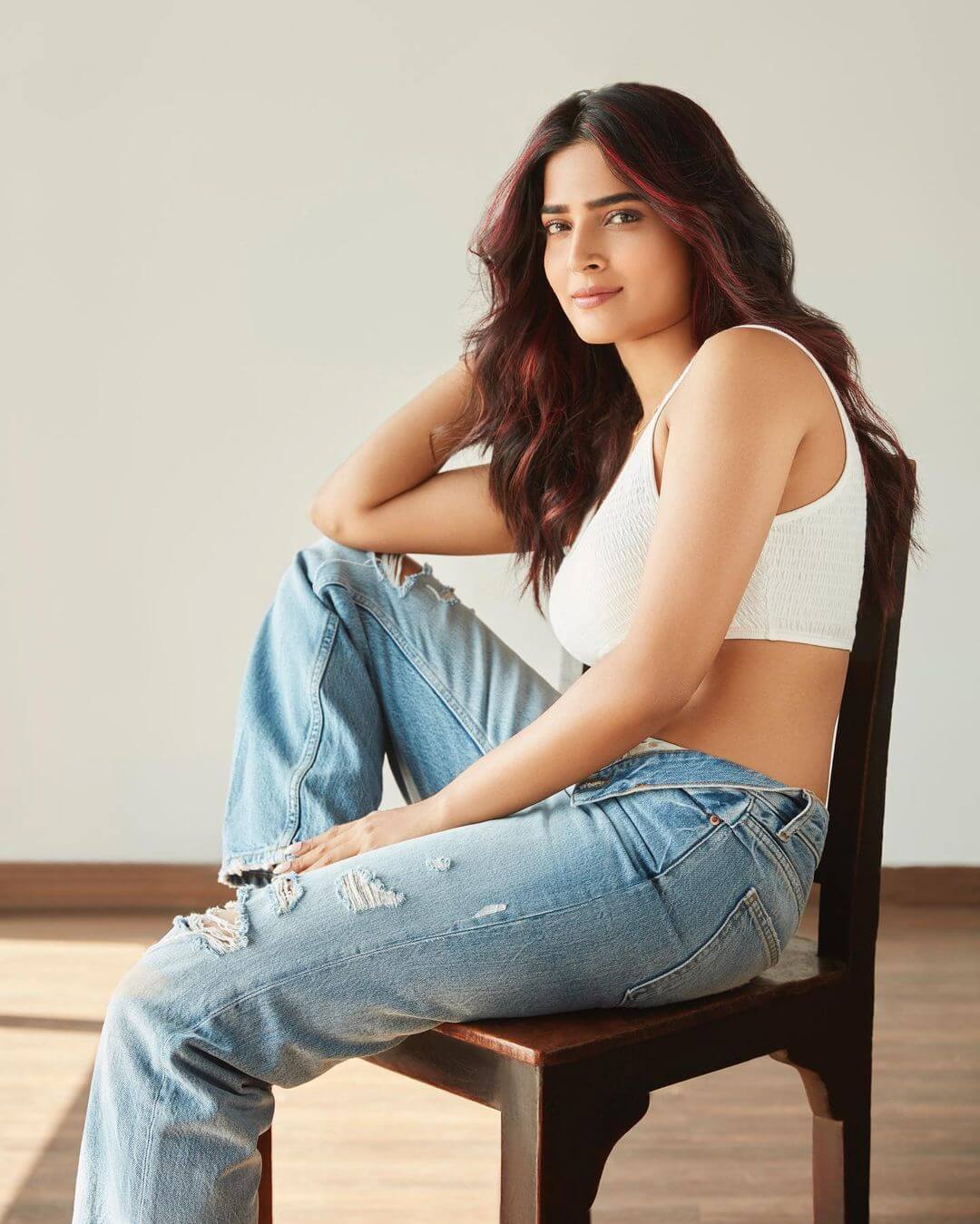 Tollywood Actress Anagha Maruthora  In White Spaghetti Strap White Crop Top With Distressed Denim Blue Jeans