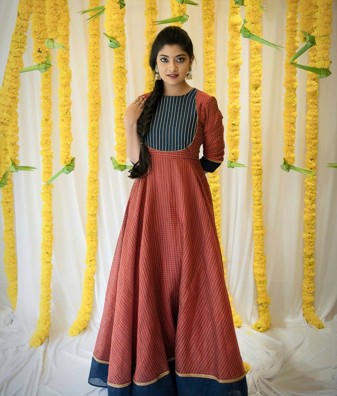 Ammu Abhirami In Traditional Red Colored Jacquard Square Pattern Gown