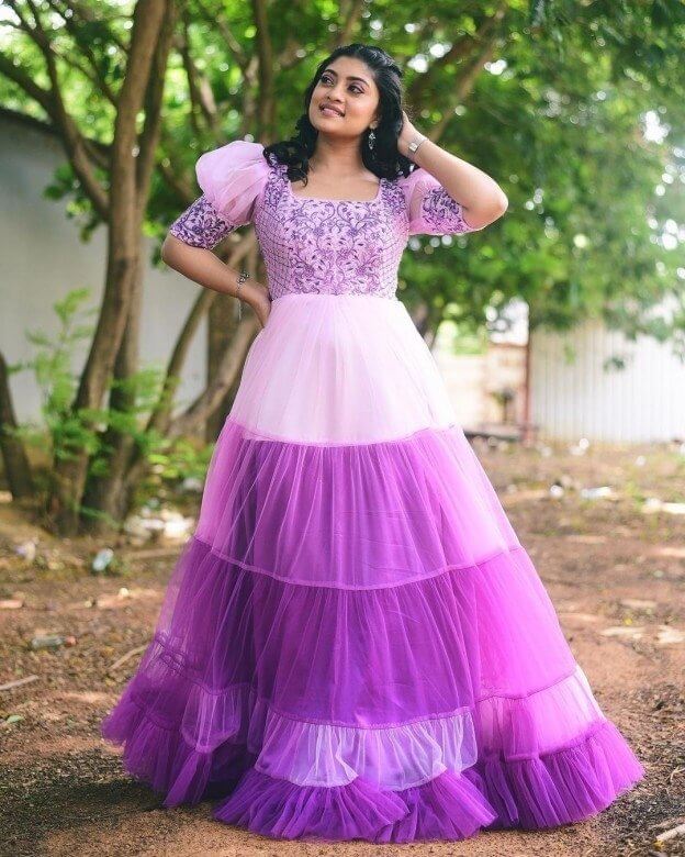 Ammu Abhirami Looks Drop-Dead Gorgeous In a White & Purple Embroidered Net Ruffled Long Gown