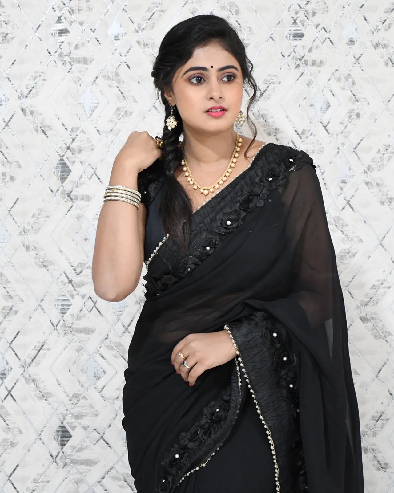 beautiful-meghasri-in-black-floral-lace-saree-paired-and-sleeveless-black -blouse-with-braided-hairstyle - K4 Fashion