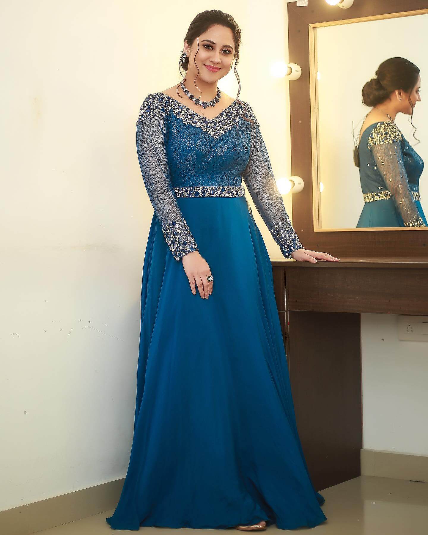 Miya George In Teal Blue Stone Embedded Full Sleeves Gown With Low Bun Hairstyle Traditional & Western Looks