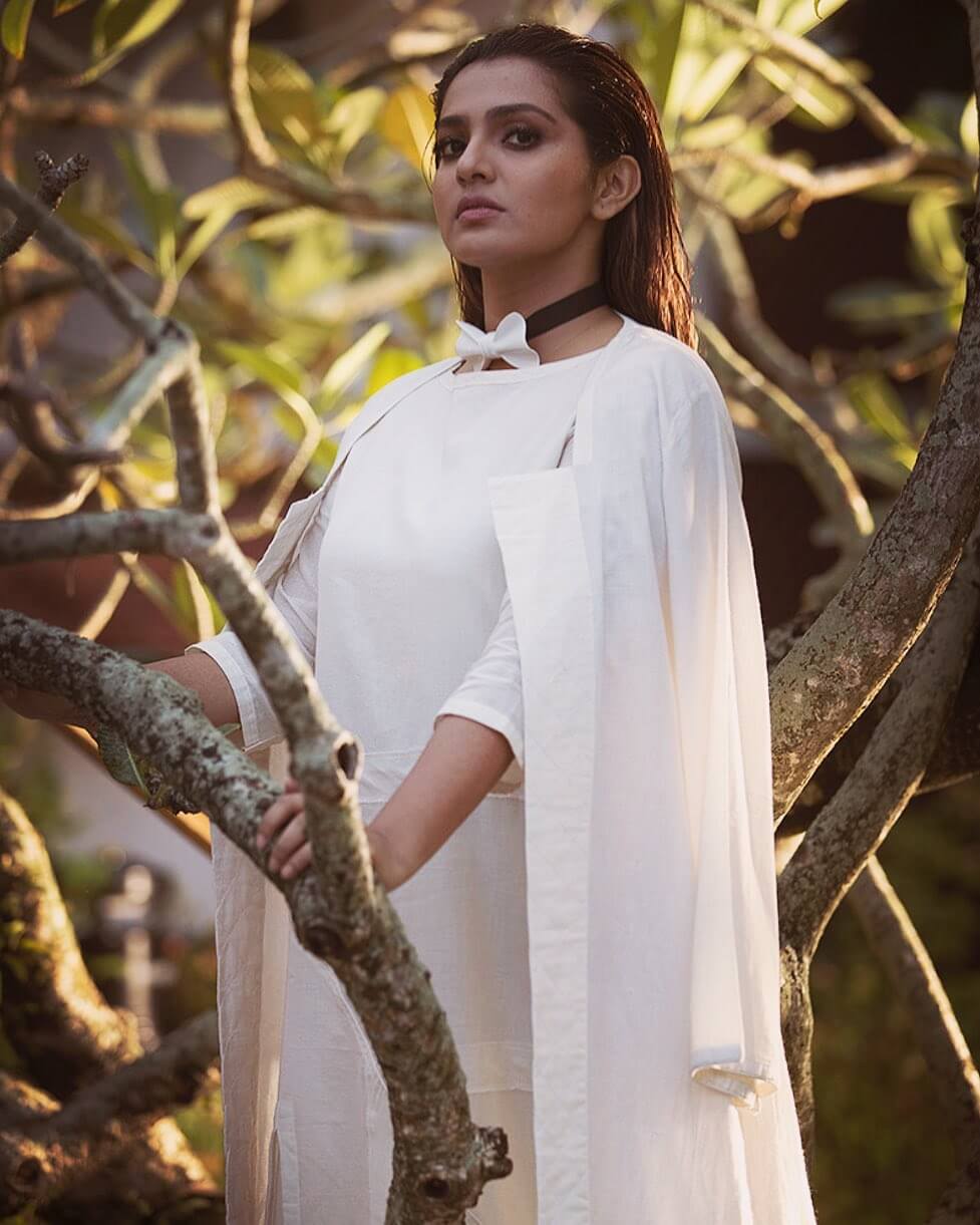 Parvathy Thiruvothu In White Dress With Jacket Styled With Bow Tie & Sleek Open Hair Outfits, Looks & Fashion