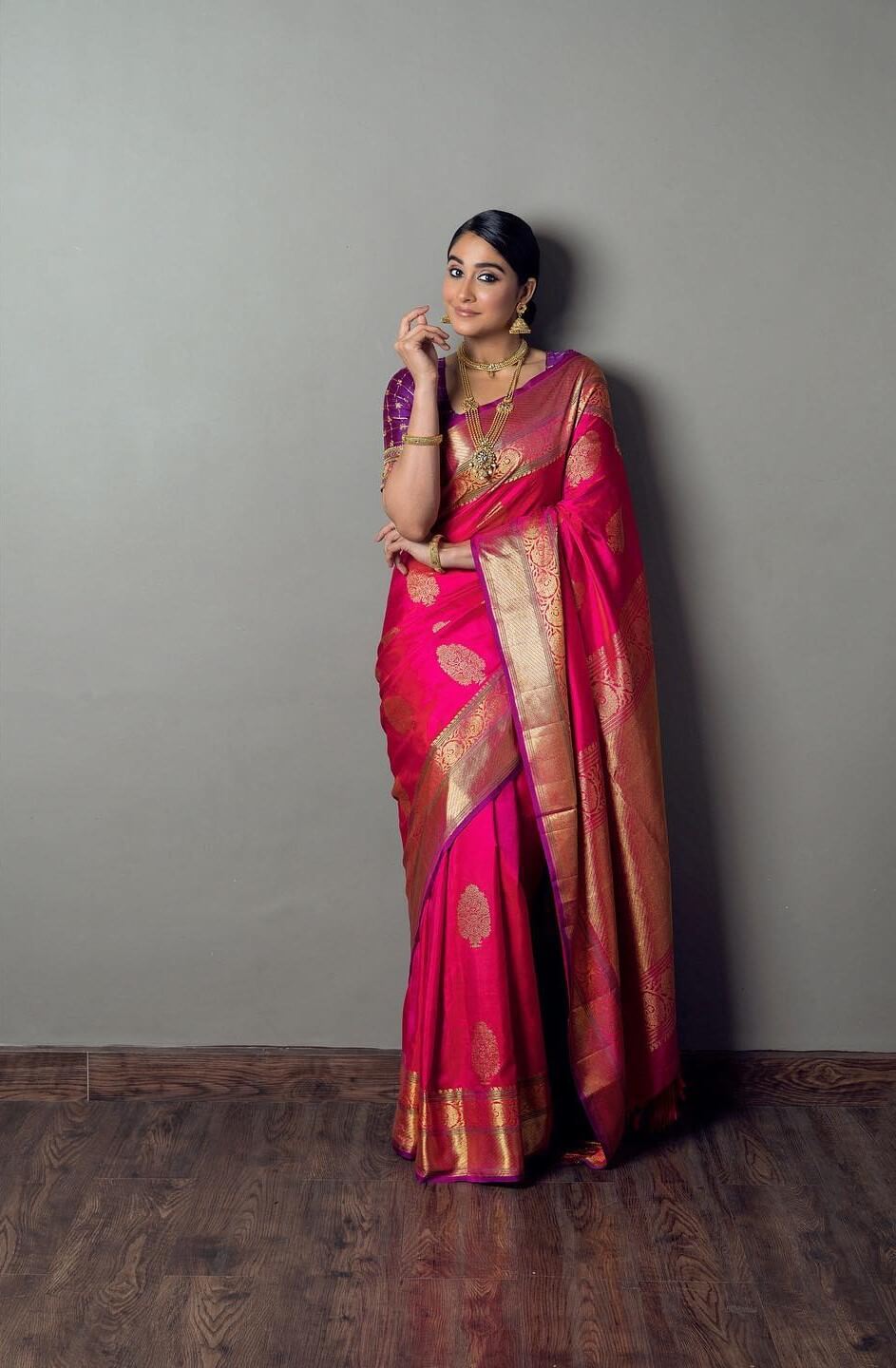 Regina Cassandra In Pink Gold Zari Woven Saree Paired With Purple Blouse