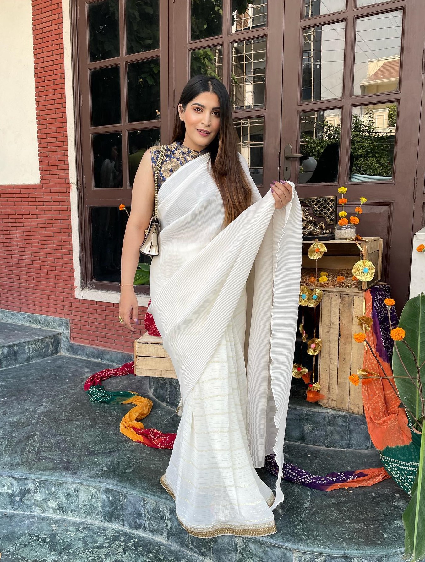 Shreya Jain In Chic White Accordion Pleated Solid Saree With High Neck Sleeveless Printed Blue Blouse Exclusive Outfits & Looks