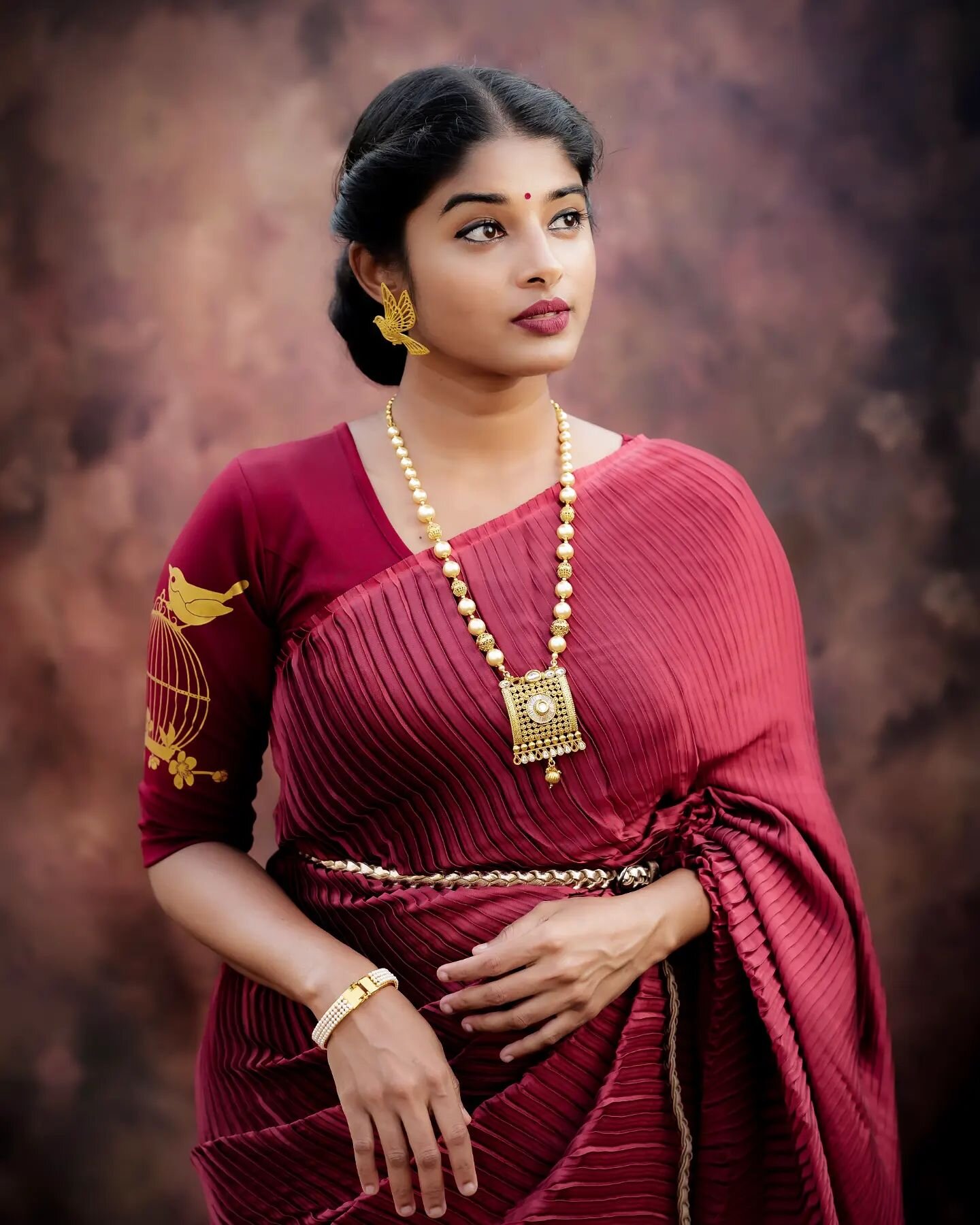 South Actress Sheela Rajkumar  In a Maroon Pleated Saree With Printed Sleeves Blouse Styled With a Braided Waist Belt