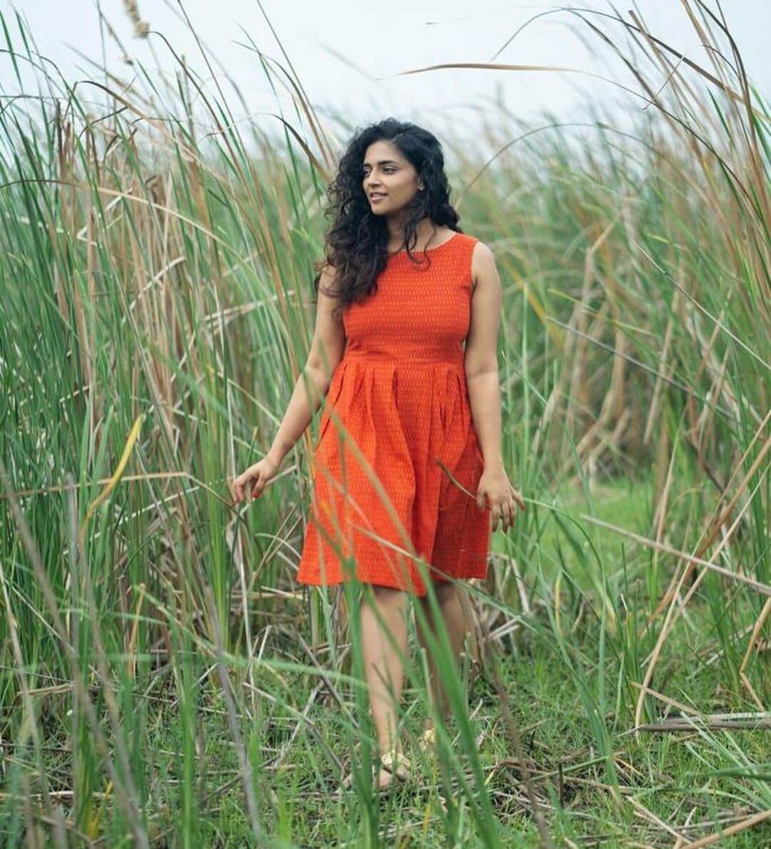 Vasundhara Kashyap In Orange Cotton Pleated Fit & Flare Dress With Curly Hair