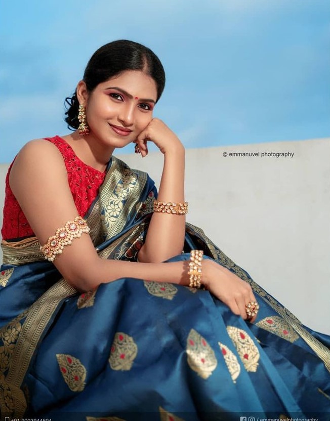 Venba In Blue Silk Saree Paired With Red Sleeveless Blouse