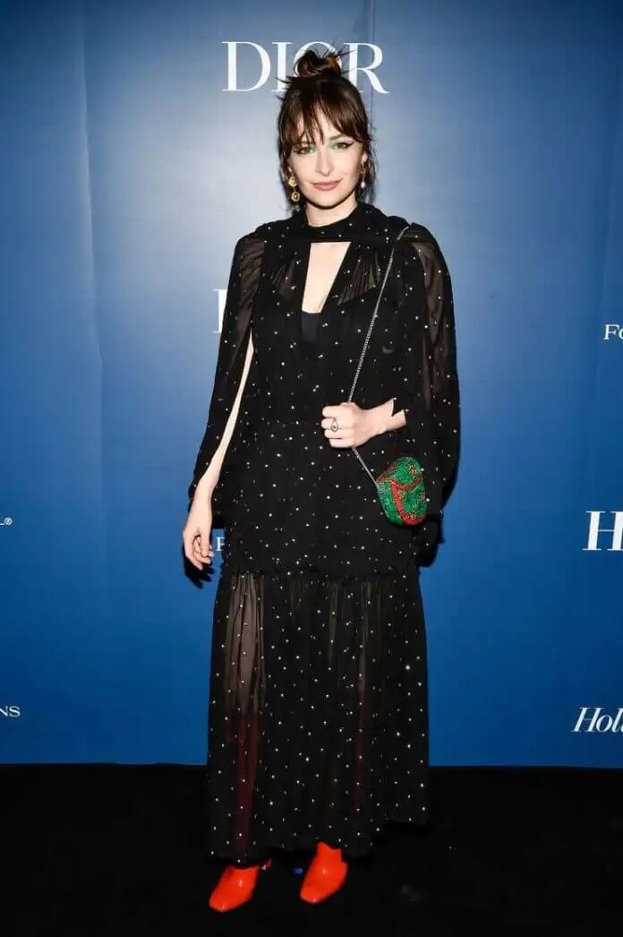 Ashleigh Cummings In Dotted Black Outfit With Green Color Handbag