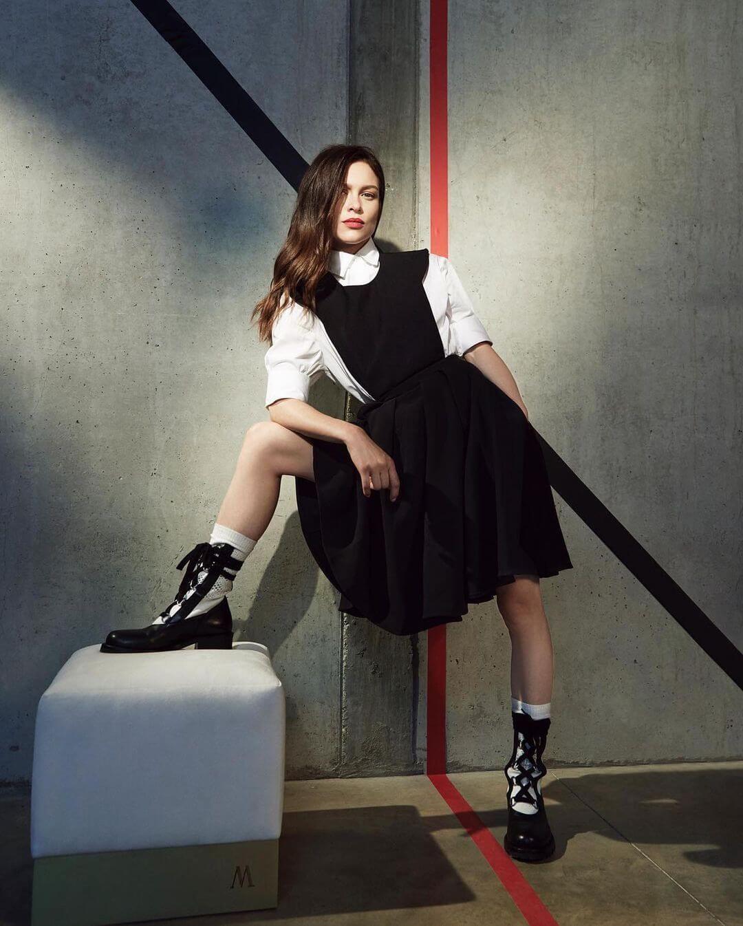 Elegant Style: Sophie Cookson's White Shirt and Black Skirt Look