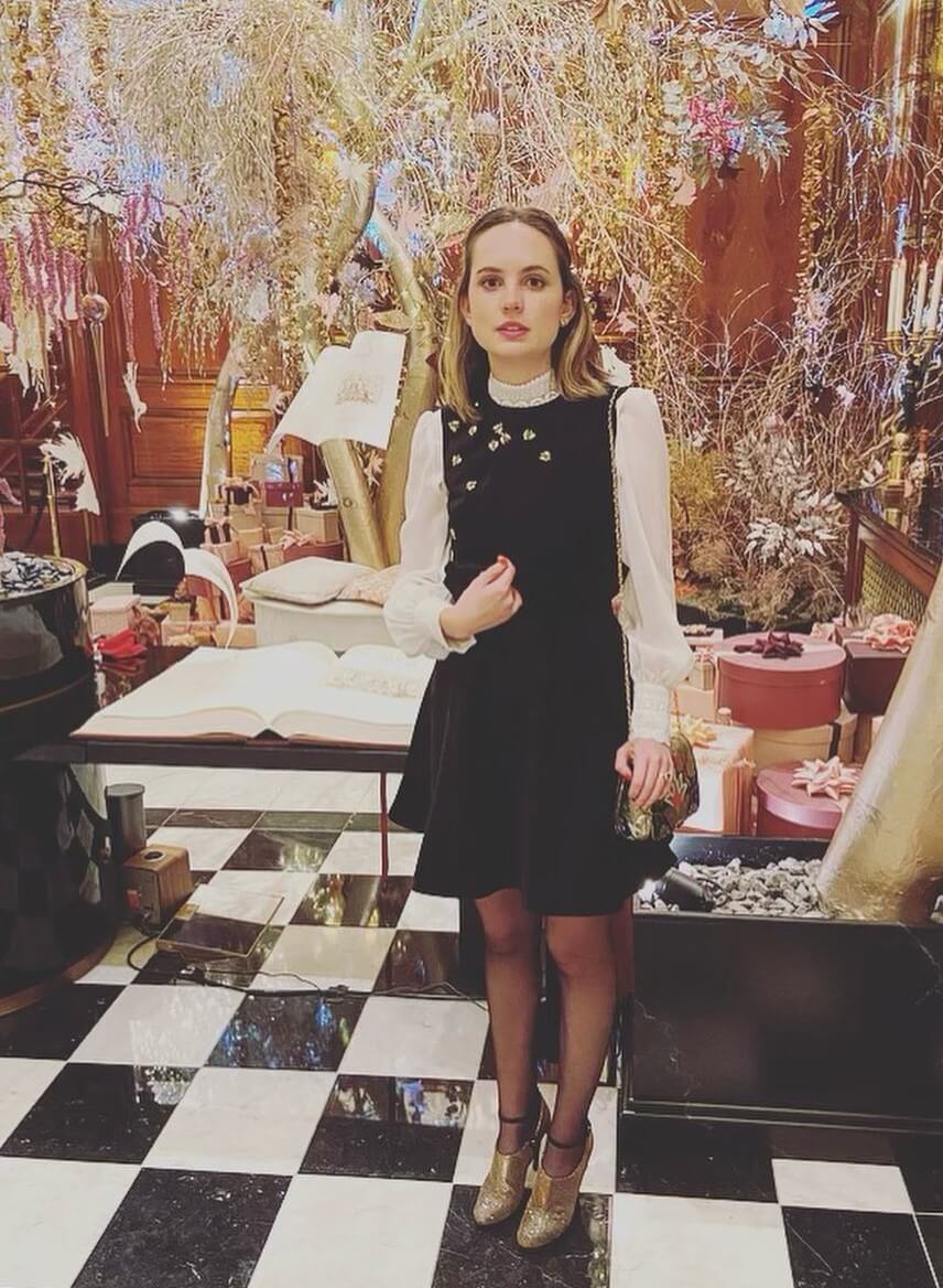 Meaghan Martin's Chic Black Mini Dress with Floral Appliques and a Puffed Sleeve Top