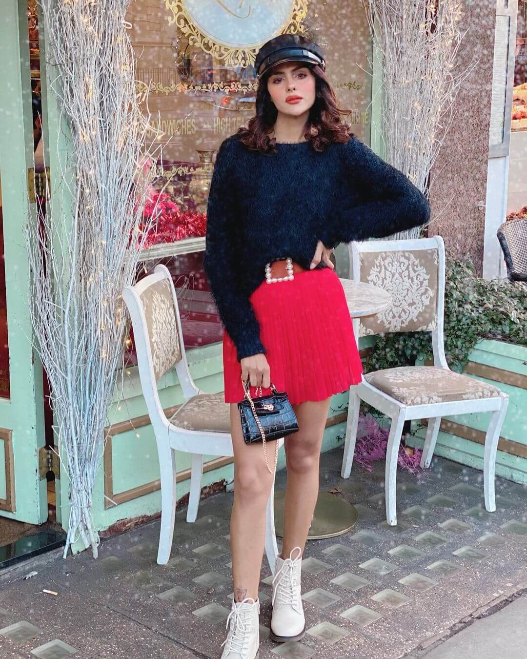 Priyanka Choudhary Chic Winter Look In Black Pullover With Red Pleated Skirt