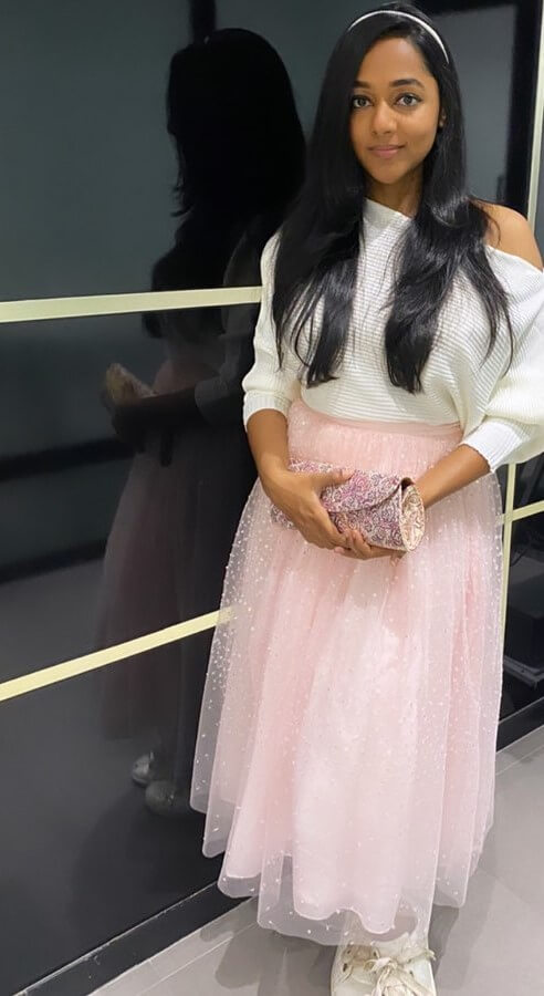 Santhy Balachandran Twirls In White Off Shoulder Baggy Top With Glittery Skirt