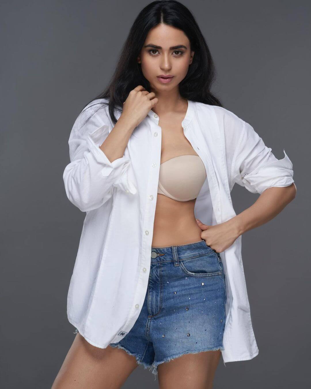 Soundarya Flaunting Her Figure In Blue Shorts With White Baggy Shirt & Beige Bralette