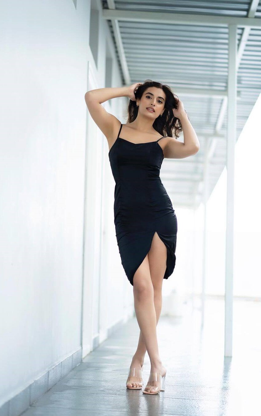 Actress Divyansha Kaushik In Black Body Hugging Noddle Strap Short Dress