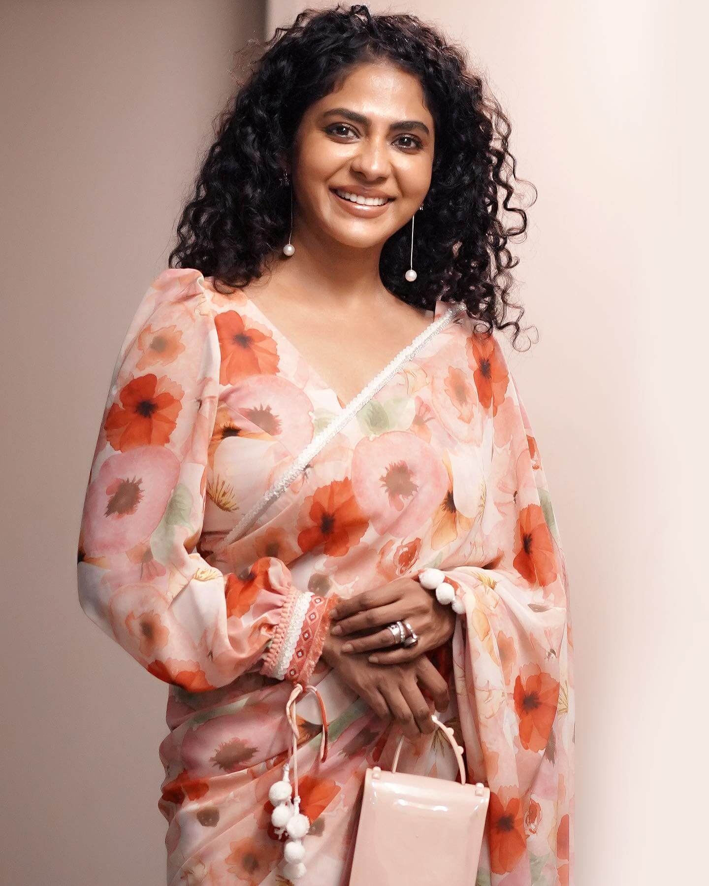 Poornima Indrajith In Peach Floral Printed Saree With Monotone Puffed Sleeves Blouse