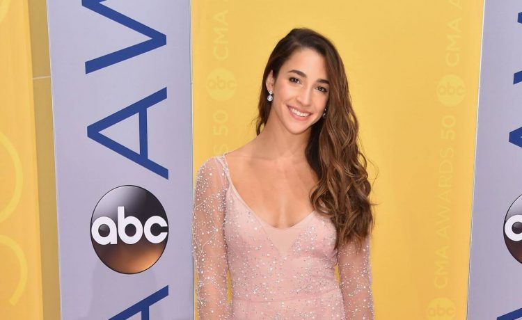 Aly Raisman -In Dusky Pink Full Sleeves Transparent Net Flared Long Gown With Silver Clutch