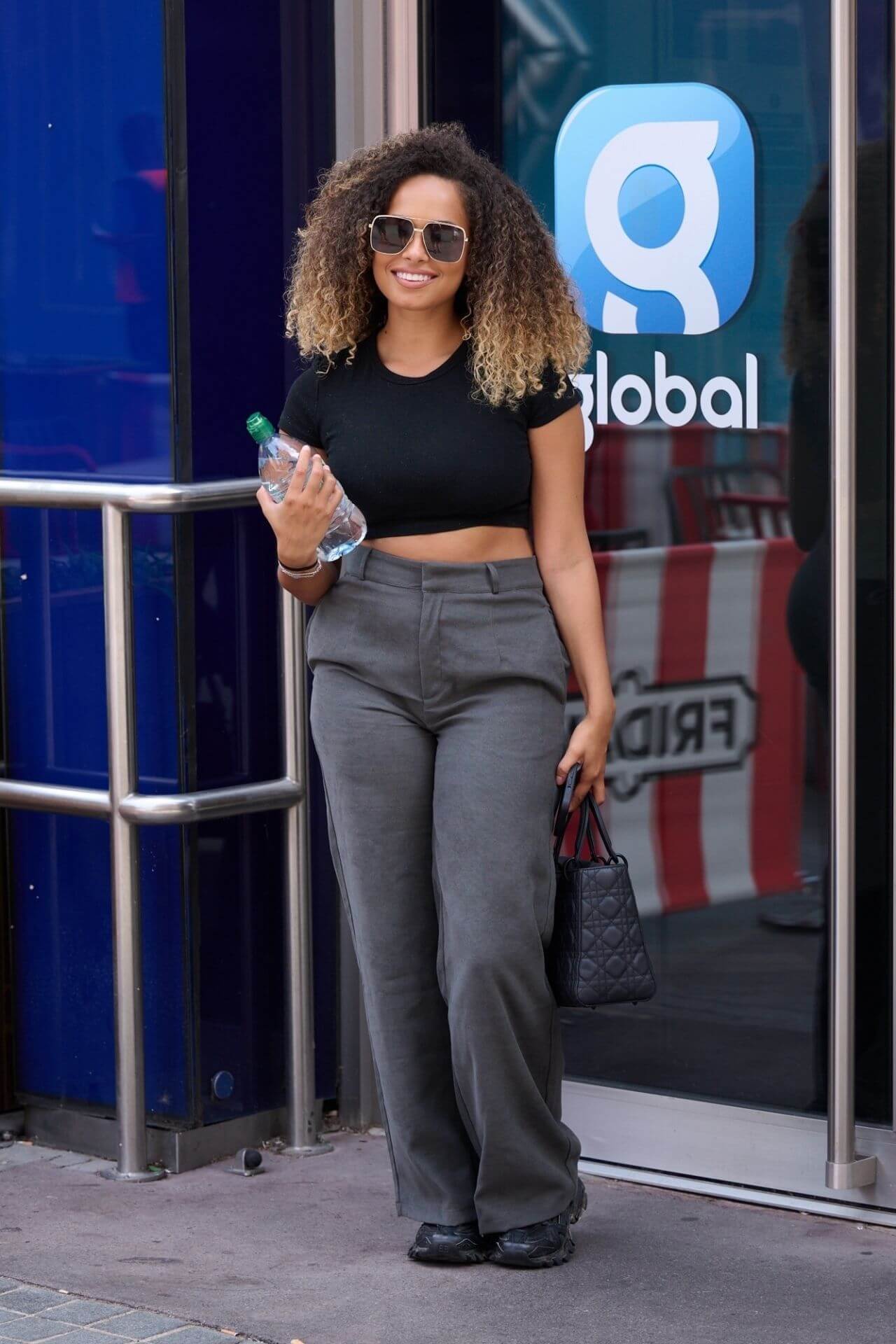Amber Gill In Black Crop Top With Grey Pants Out in London
