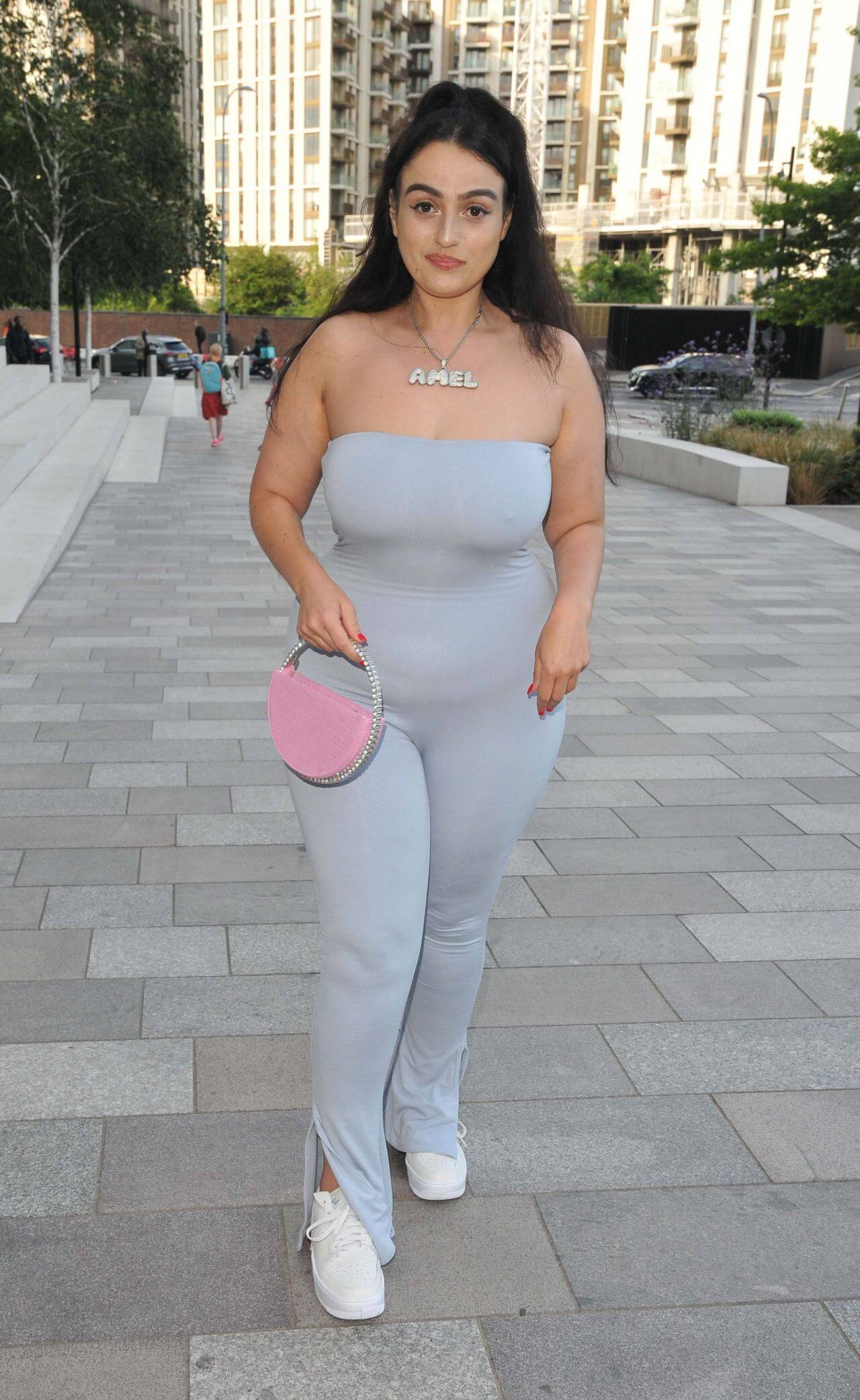 Amel Rachedi  In Ice Blue Off-Shoulder Jumpsuit With Pink Clutch At“Legends Never Die” VIP Screening in London