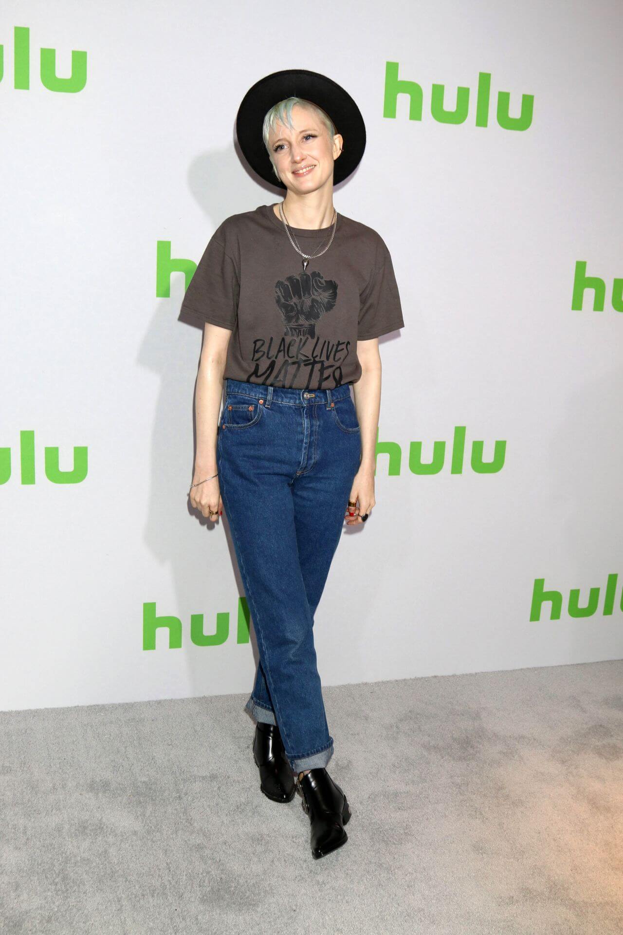 Andrea Riseborough In  Brown T-shirt & Blue Denim Jeans With Black Hat At HULU TCA Winter Photo Call in Pasadena