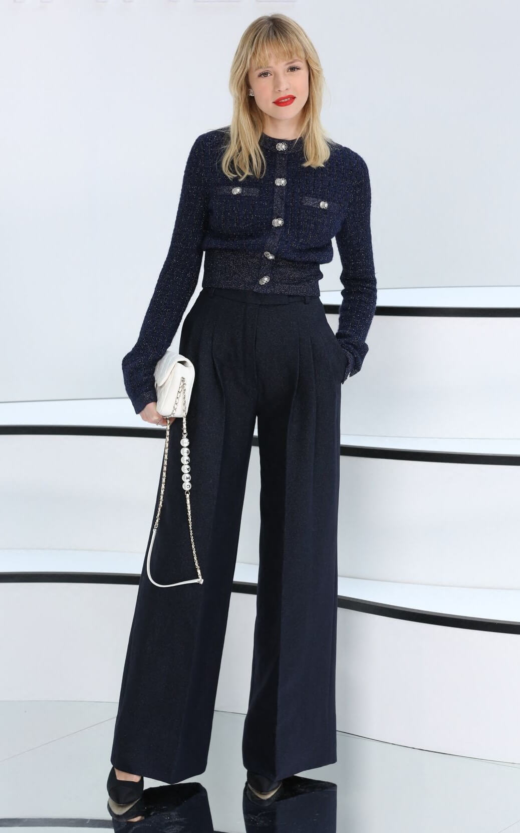 Angele  In Blue Full Sleeves Woven Top & Flare Pants With White Handbags At Chanel Show at Paris Fashion Week
