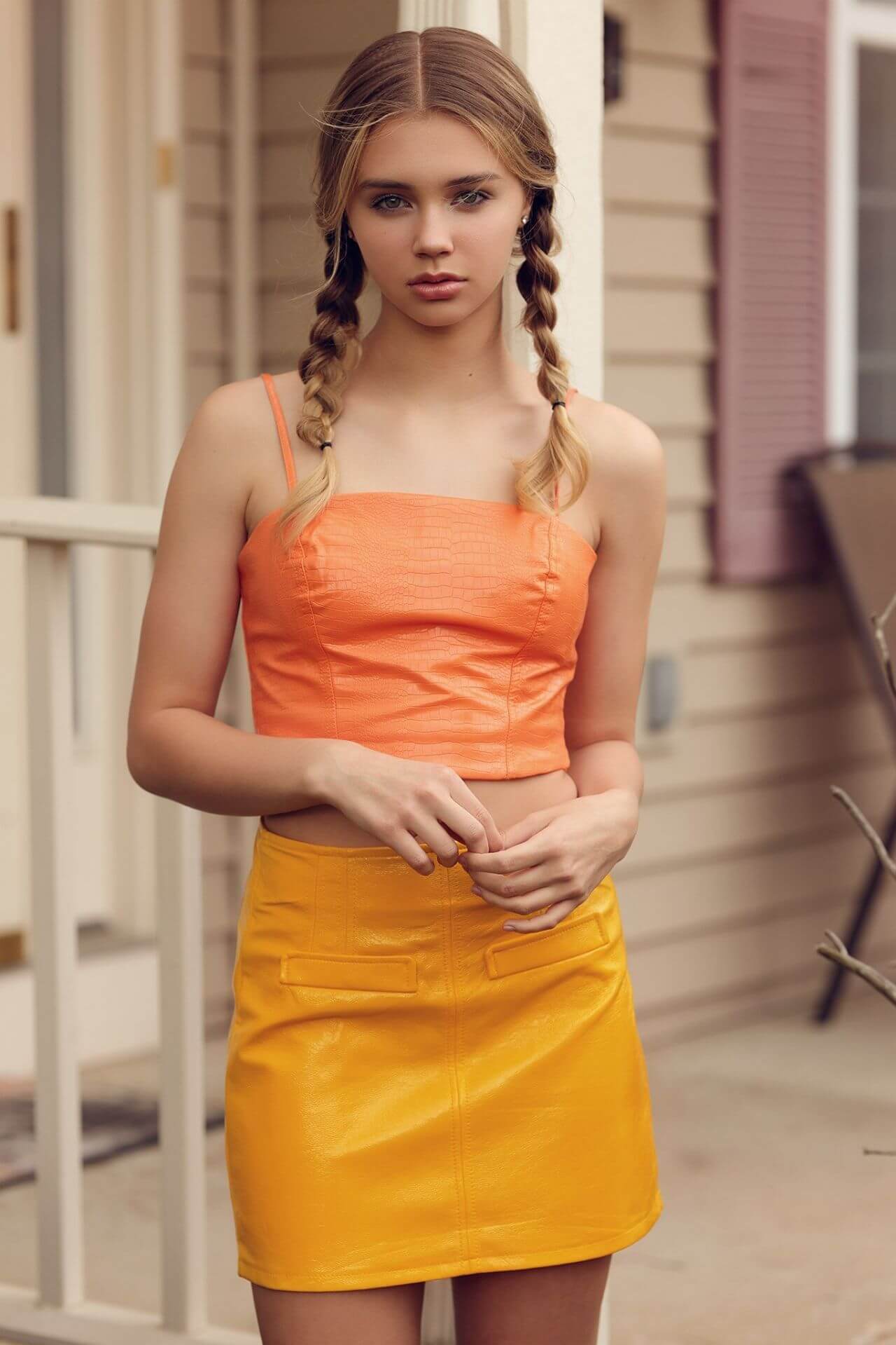 Angelina Polikarpova In Orange Strap Sleeves Crop Top With Yellow Leather Mini Skirt Outfits
