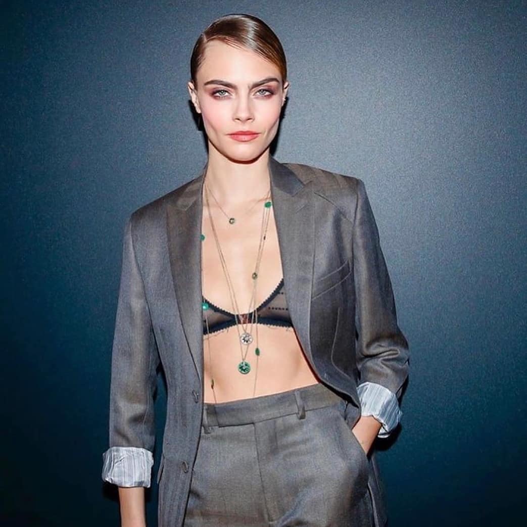 "Breaking All Conventional Fashion Rules: English Model Rocks Charcoal Grey Pant Suit with Emerald Studded Tiered Necklace" - Cara Delevingne