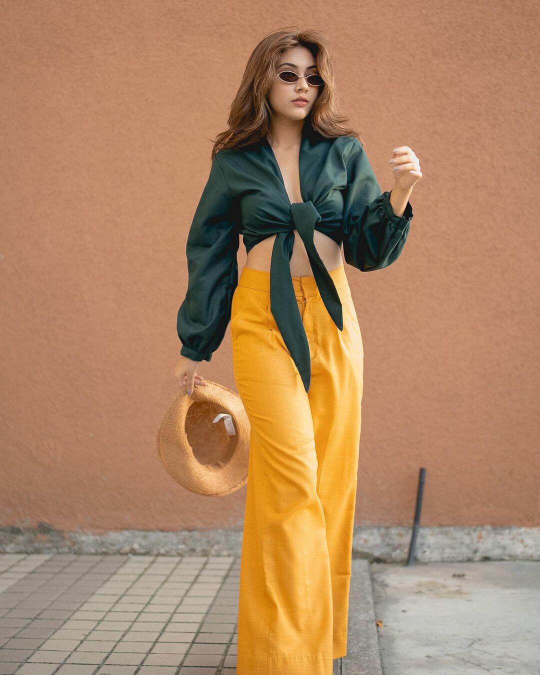 Reem Shaikh Let Go On Vacation Look In Green Tie On Top With Yellow Pants Styled With a Cool Hat & Shades