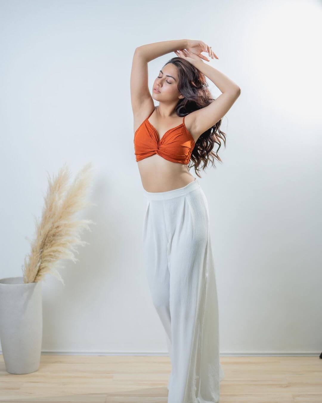 Reem Shaikh Strike A Sexy Pose In Orange Corset With White Flared Pants