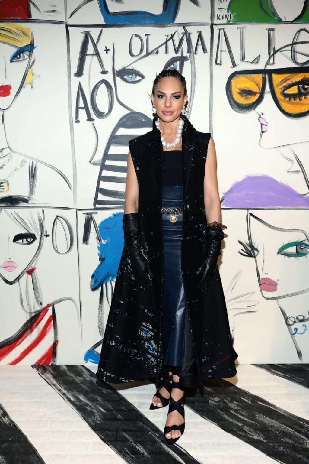 Amanza Smith In Black Shimmery Long Sleeveless Jacket & Blue Leather Skirt With Pearl Garland At Fashion Show in New York
