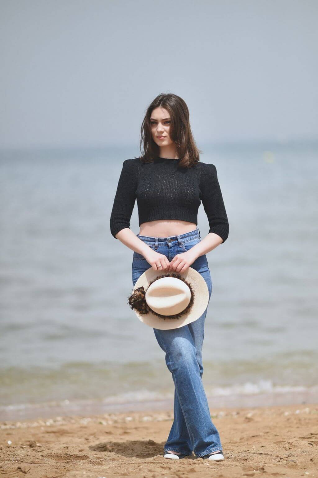 Anamaria Bartolomei In Black Full Sleeves Crop Top With Blue Denim Jeans At 36th Cabourg Film Festival Photocall