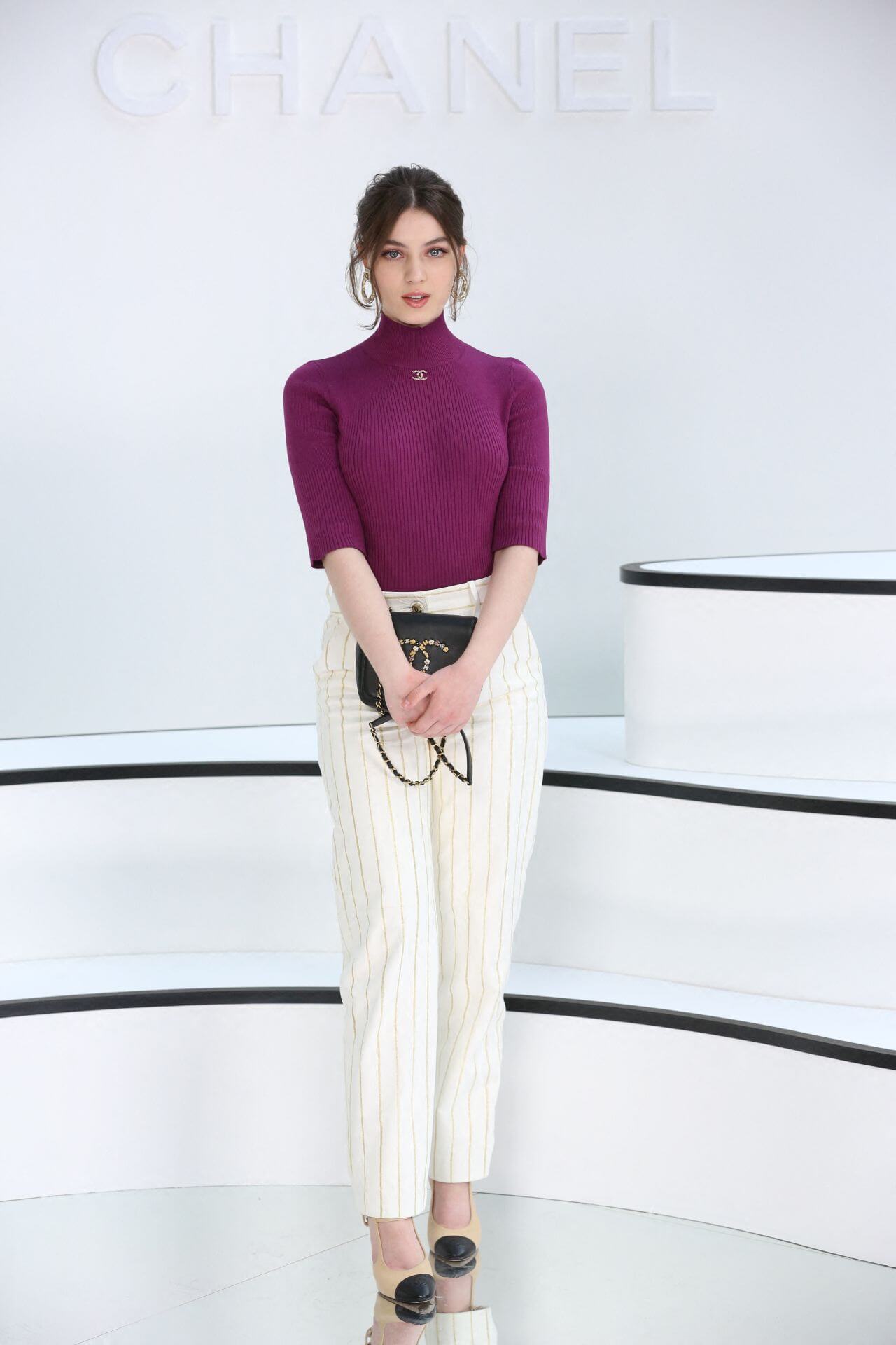 Anamaria Bartolomei In Purple Woolen High Neck Crop Top With Stripped Pants At  Chanel Show at Paris Fashion Week